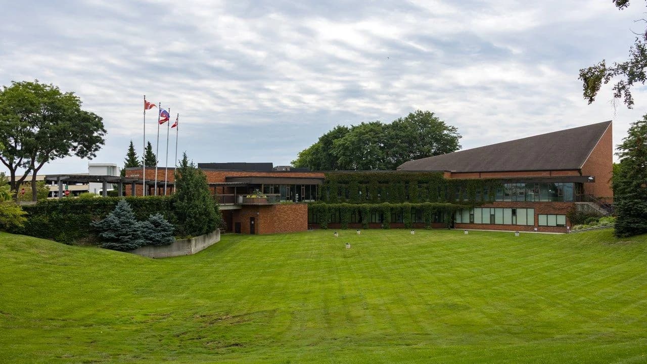 The Whitby Town Hall building on Rossland Road in Whitby, Ontario, photographed on a cloudy day