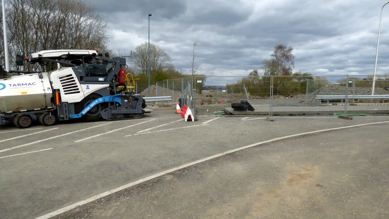 An asphalt paving machine at a road construction site