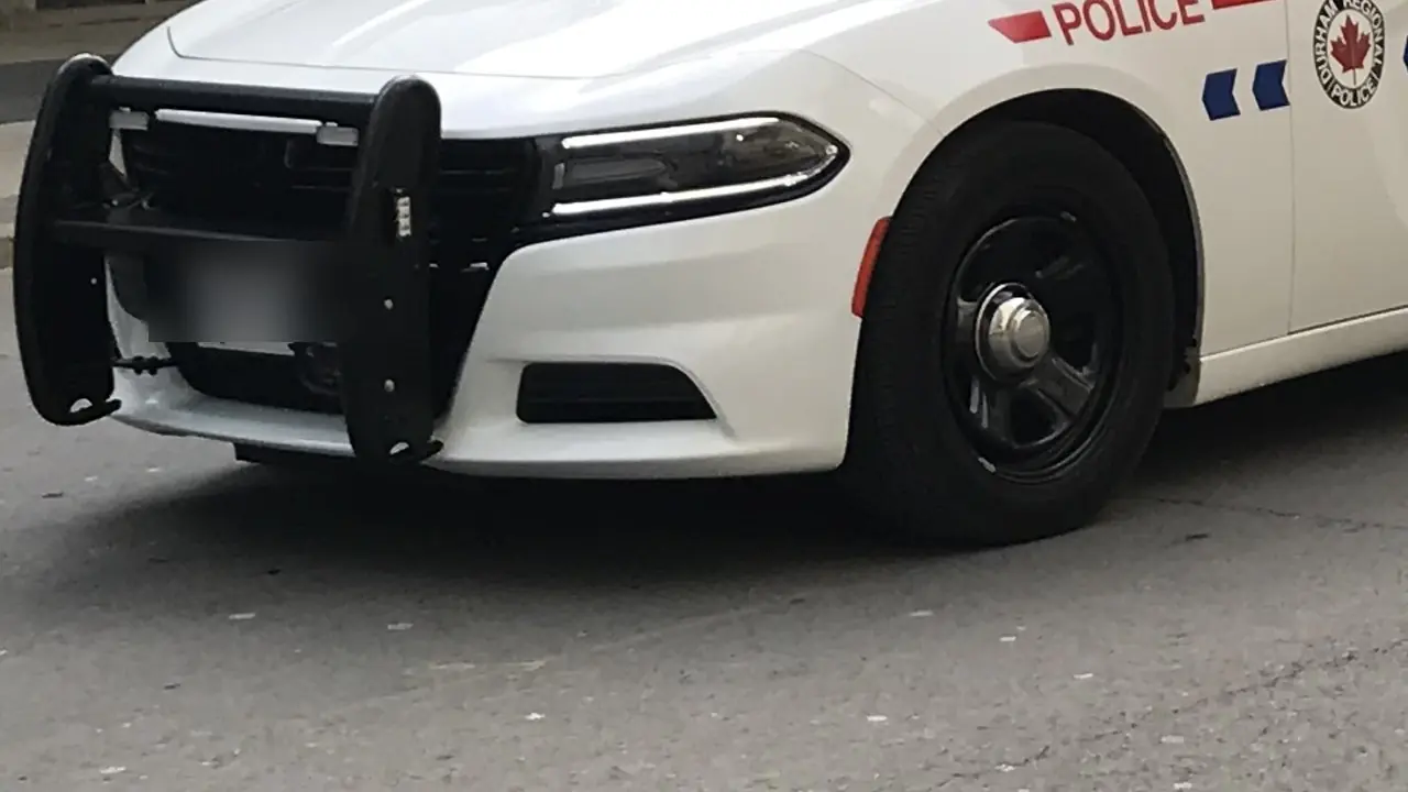 Front of a Durham Regional Police marked cruiser with push bar, POLICE lettering and service badge; no people shown.